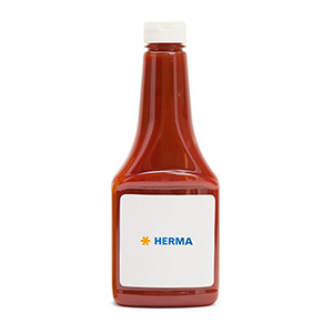 Flasche mit roter Flüssigkeit, beschriftet mit "HERMA" auf einem weißen Etikett.
