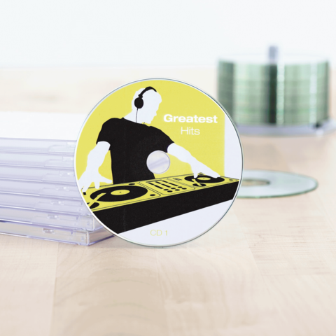 CD mit dem Titel "Greatest Hits", abgebildet mit einem DJ-Design auf gelbem Hintergrund, neben transparenten CD-Hüllen.