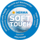 Rundes Etikett mit dem Text "HERMA SOFT TOUCH", das auf weiche Haptik, Elastizität und den Verzicht auf Weichmacher hinweist.