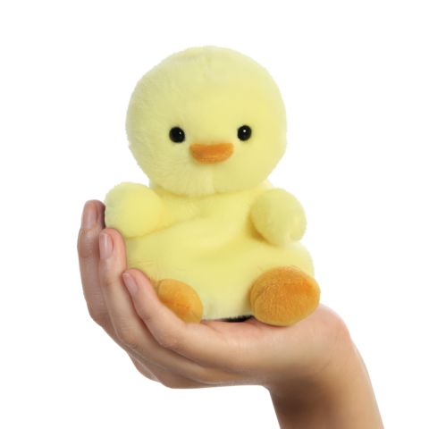 Eine Hand hält ein gelbes, weiches Entchen mit schwarzen Augen und einem orangefarbenen Schnabel.
