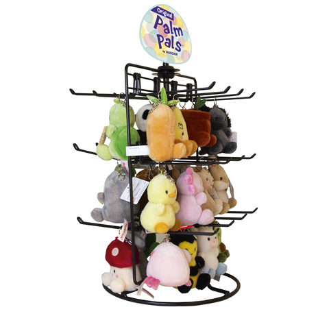 Ein Ständer mit verschiedenen Plüschspielzeugen, darunter Tiere und Figuren, mit einem Schild "Original Palm Pals" von Aurora.