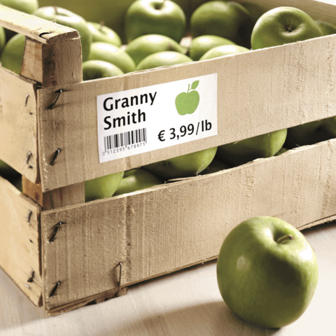 Kiste mit Granny Smith Äpfeln, Preisetikett zeigt € 3,99 pro Pfund. Äpfel sind grün und frisch.